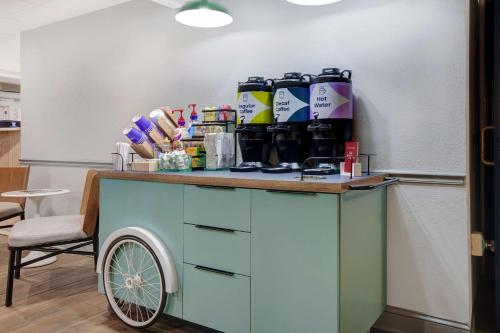 a table with a cart in a room at Spark By Hilton Rochester University Area in Rochester