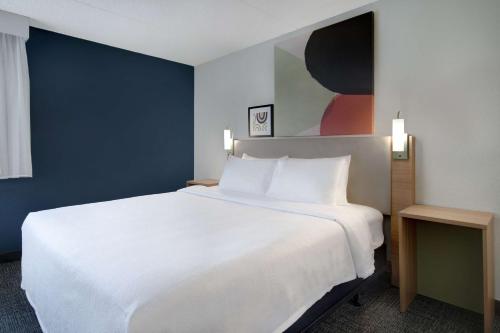 a large white bed in a hotel room at Spark By Hilton Rochester University Area in Rochester