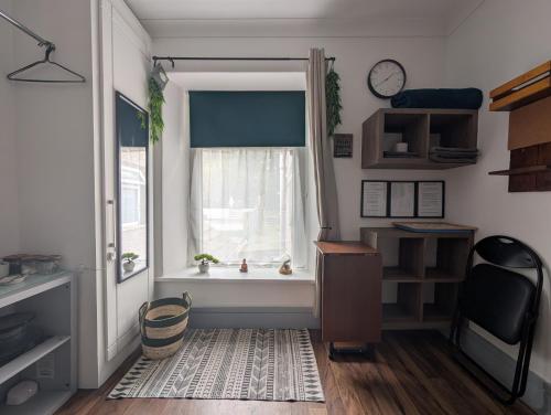 a small room with a window and a desk and a desk at R4 - New Relaxing Double - City & Beach Access, WIFI, Free Parking - Self Catering in Swansea
