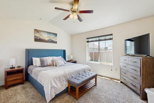 a bedroom with a blue bed and a ceiling fan at Bridger View Retreat in Belgrade