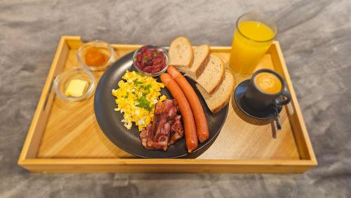 a plate of food with sausage and eggs and toast at Boutique wine rezidence in Hnanice