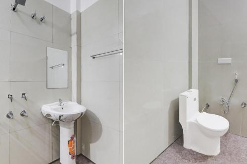 a white bathroom with a sink and a toilet at HOTEL O YASH RAJ PALACE in Rāe Bareli