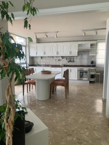 a large kitchen with a table and chairs in it at Tenerife Stay Ocean Front I in San Marcos