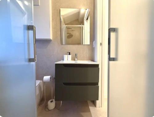 a bathroom with a sink and a mirror at Rimini Centrale - Appartamento Moderno in Rimini