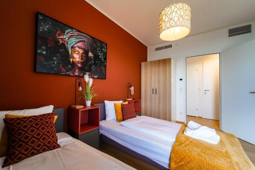 a bedroom with two beds and a painting on the wall at Wonderful Apartment with 2 bedrooms and pool and parking in Vienna