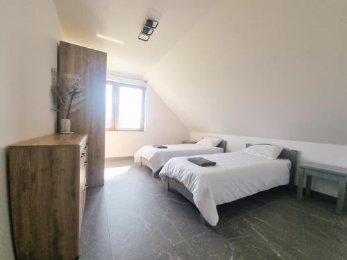 a bedroom with two beds and a window at Kika House in Pasym