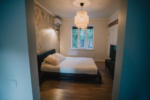 a small bedroom with a bed and a window at Portside studio, free parking, self check-in in Klaipėda