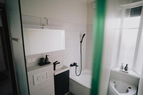 a bathroom with a shower and a toilet and a sink at Portside studio, free parking, self check-in in Klaipėda