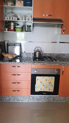 a kitchen with an oven with a pot on it at Marina Golf Appartement HS in Asilah