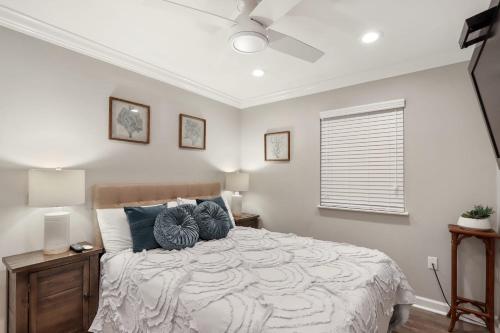 a bedroom with a large bed with blue pillows at Unspoiled Beachfront Villa Sunrises from Balcony in Hilton Head Island