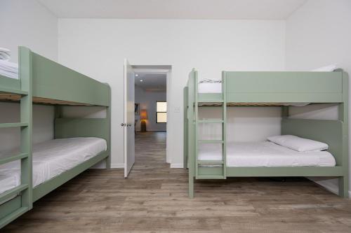 two bunk beds in a room with a hallway at Phoenix II 2151 condo in Romar Beach