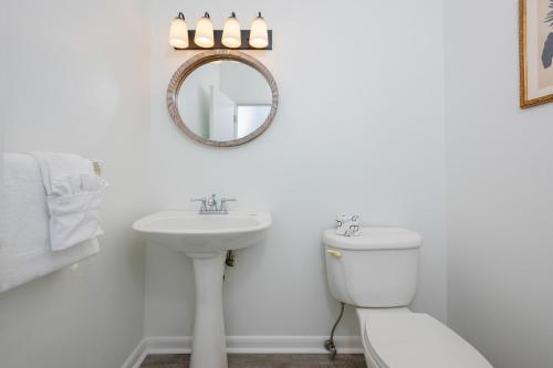 a bathroom with a sink and a toilet and a mirror at Phoenix II 2151 condo in Romar Beach