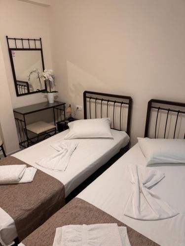 two beds sitting next to each other in a bedroom at Paradise Garden Paros in Piso Livadi
