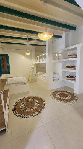 a room with two bunk beds and a table at Casa Blanca - calm space for soul revival in Ādam