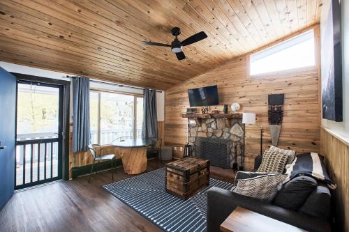 a living room with a couch and a fireplace at Misty Mountain Lodge in Estes Park