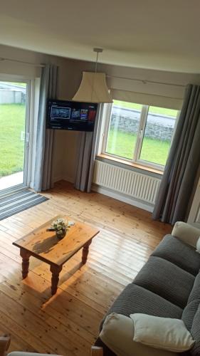 a living room with a couch and a coffee table at Coastal Breeze holiday home Enniscrone in Enniscrone
