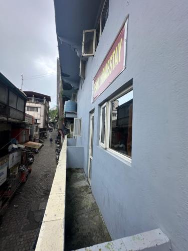 a building with a sign on the side of it at Pearl Homestay Mussoorie in Mussoorie