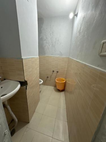 a bathroom with a shower and a sink and a toilet at Pearl Homestay Mussoorie in Mussoorie