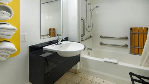 a bathroom with a sink and a bath tub and a sink at Motel 6-Longview, TX in Longview