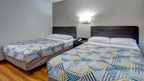 a hotel room with two beds in a room at Motel 6-Longview, TX in Longview