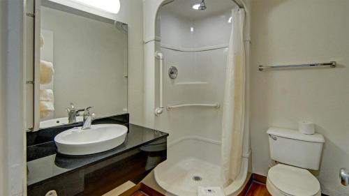 a bathroom with a toilet and a sink and a shower at Motel 6-Longview, TX in Longview