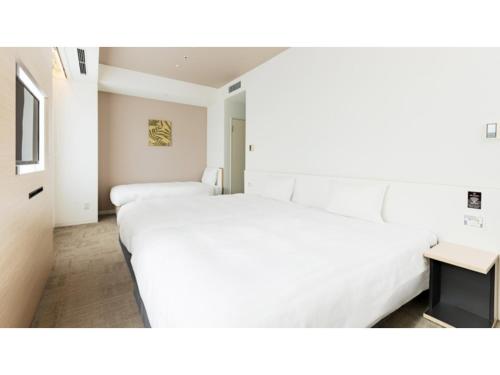 En eller flere senge i et værelse på The OneFive Sendai - Vacation STAY 35279v