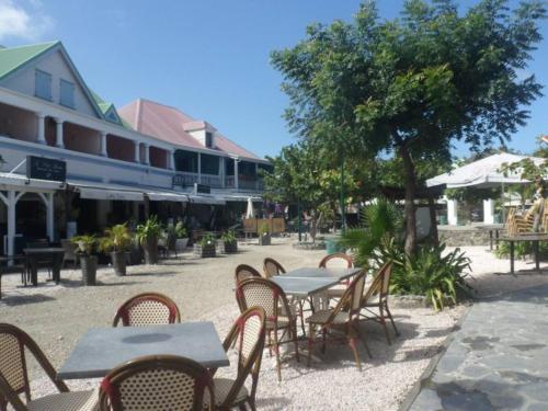 a group of tables and chairs in front of a building at Villa Redfish in Orient Bay