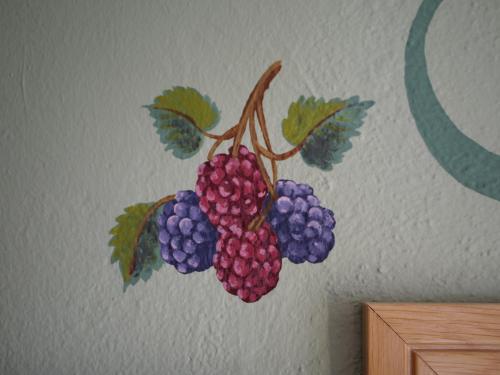 a painting of a bunch of grapes on a wall at La Casa Della Seta in Mezzegra