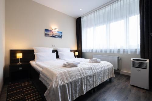 Ένα ή περισσότερα κρεβάτια σε δωμάτιο στο home Hotel