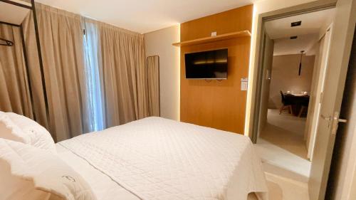 Katil atau katil-katil dalam bilik di Jardins Almare Apart Hotel