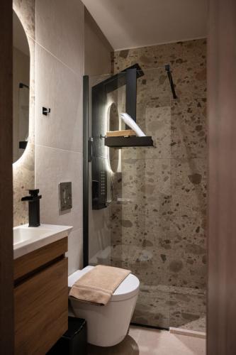 a bathroom with a toilet and a sink and a shower at Centre Ville Local Stays in Argos