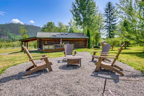 a group of chairs and a table in front of a cabin at Private Deck Dog-Friendly Arlington Cabin in Arlington