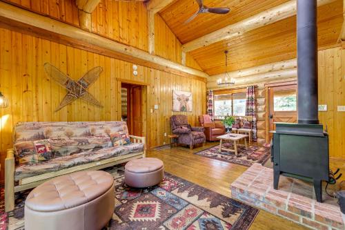 a living room with a couch and a stove at Private Deck Dog-Friendly Arlington Cabin in Arlington