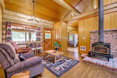 a living room with a fireplace in a log cabin at Private Deck Dog-Friendly Arlington Cabin in Arlington