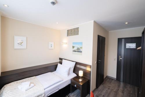 Ένα ή περισσότερα κρεβάτια σε δωμάτιο στο home Hotel