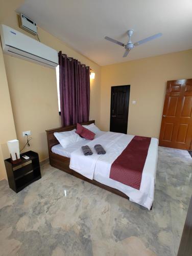 a bedroom with a large bed with two towels on it at Casa Santana in Dabolim