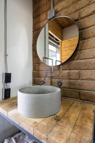 a bathroom with a round sink and a mirror at Argentina by Pardela - LOFT nuevo Colonia Americana in Guadalajara