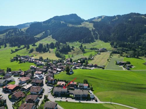 an aerial view of a small village in the mountains at Allgäutraum in Bolsterlang