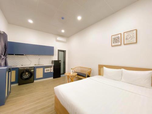 a hotel room with a bed and a kitchen at Urbanest Saigon in Ho Chi Minh City