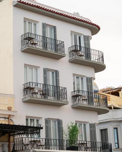 a building with balconies on the side of it at Centre Ville Local Stays in Argos