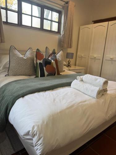a bedroom with two beds with towels on them at Rivonia Garden Suites in Johannesburg