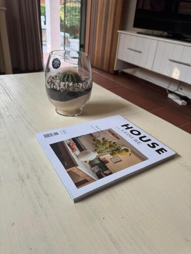 a book and a vase and a magazine on a table at Rivonia Garden Suites in Johannesburg