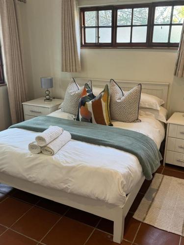 a bedroom with two beds with pillows on them at Rivonia Garden Suites in Johannesburg