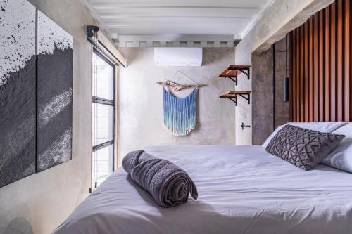 a bedroom with two beds and a large window at Z102 Studios, 4 Industrial Beach Condos w Pool! in Playa Flamingo