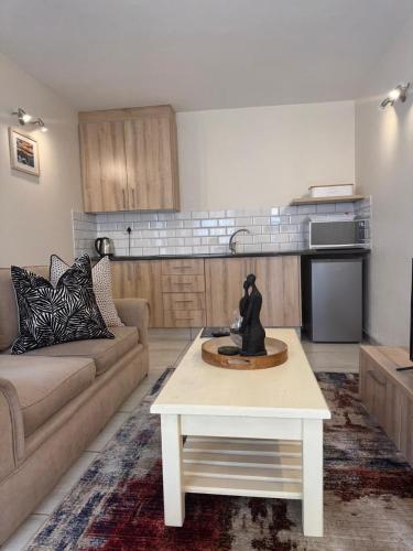 a living room with a couch and a coffee table at Rivonia Garden Suites in Johannesburg