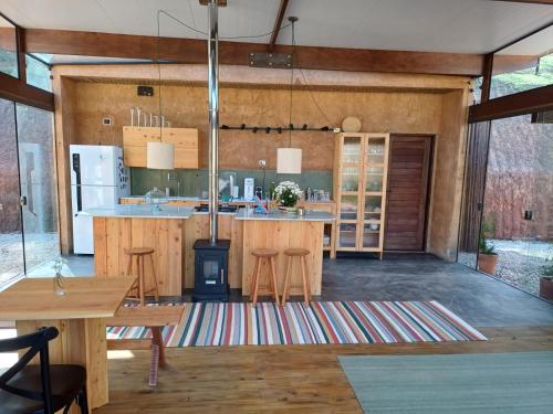 an open kitchen with wooden cabinets and a kitchen island at Fraga da Mantiqueira in São Bento do Sapucaí