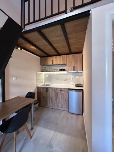 a kitchen and dining room with a table and chairs at Sea&Salt Luxury Rooms in Nea Kalikratia