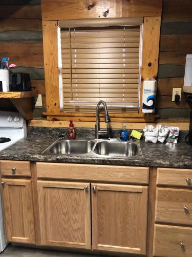 a kitchen with a sink and a window at Lookout Mtn cabin with a view in Rising Fawn