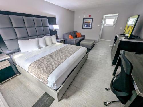 a hotel room with a large bed and a desk at SOHO Suites Atlantic City Beach Block in Atlantic City