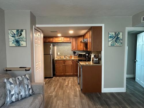 a living room with a couch and a kitchen at Deland Serenity Place #1 in DeLand